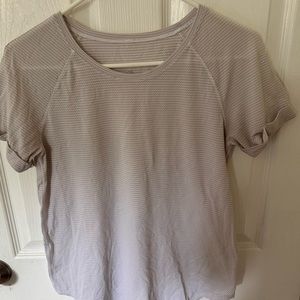 Lululemon size 4 t shirt in fair condition. Well loved but still life left.